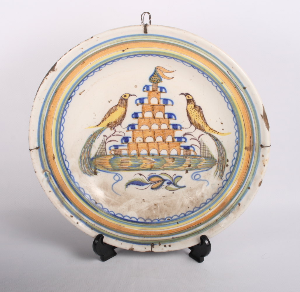 An 18th Century Delft dish, centre painted two birds and tower, 13 1/2" dia