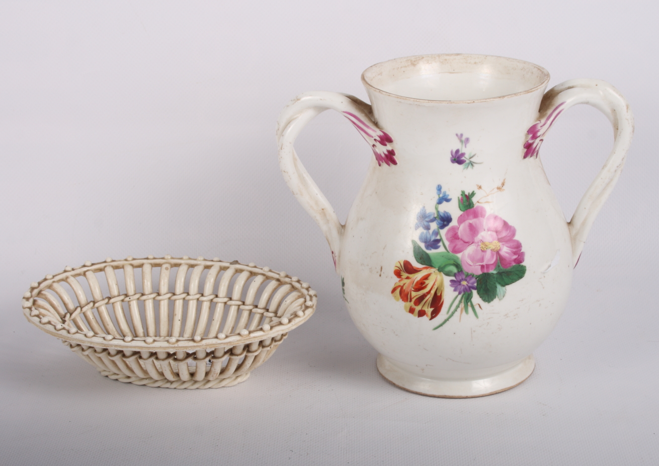 A Vienna porcelain vase with entwined handles and floral decoration and a Vienna oval creamware