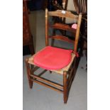 A rush seat ladderback chair fitted red loose cushion and an early 19th Century dining chair with