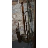 A brass shell case, fire irons, two walking sticks and a brass warming pan