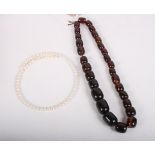 A cultured pearl choker and an 'amber' graduated bead necklace