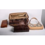 A leather Gladstone bag, a lady's crocodile handbag, a snakeskin clutch bag and one other bag
