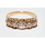 A gold and five stone diamond dress ring set old cut stones, size N