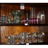 An assortment of crystal drinking glasses and vases, etc