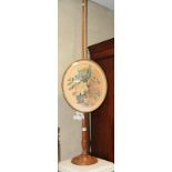 A 19th Century mahogany pole screen with oval gilt framed panel inset floral print, on circular