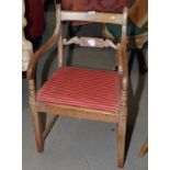 A 19th Century mahogany carver chair with drop-in seat, upholstered in a red fabric