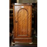 A 19th Century mahogany pedestal bedside cabinet enclosed arched panel door, 16" wide