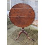 An 18th Century oak circular planked top table, on tripod splay supports, 28" dia