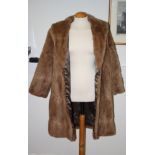 A lady's three-quarter length pastel fur coat