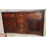 An 18th Century oak dresser base, fitted three frieze drawers and three central drawers flanked by