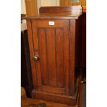 A late 19th Century mahogany bedside cabinet with boarded door and hinged top, 16" wide, and a