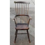 A 19th Century cane back elbow chair with elm panel seat, on turned and stretchered supports (