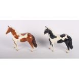 Two Beswick models of piebald and skewbald ponies (piebald repaired)