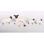 A Beswick black faced sheep, 3" high, two smaller Beswick sheep and two others