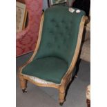 A Victorian nursing chair, button upholstered in a green fabric, with scroll carved side rails