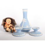 A Goebel figure of a boy under an umbrella, a pair of Wedgwood pale blue jasperware squat