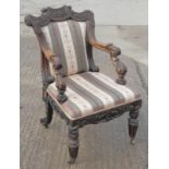 A William IV carved rosewood open armchair with acanthus scroll decoration, on shaped turned