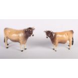 A Beswick model of a Jersey bull and cow, "Champion Dursley Coyboy" and "Champion Newton Tinkle" (