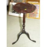 A late 19th Century mahogany circular wine table, on vase turned column and tripod splay supports,