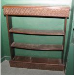 An oak open bookcase with 17th Century design carved frieze and base, 36" wide