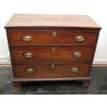 A Georgian mahogany chest of three long graduated drawers with oval brass plates, on bracket