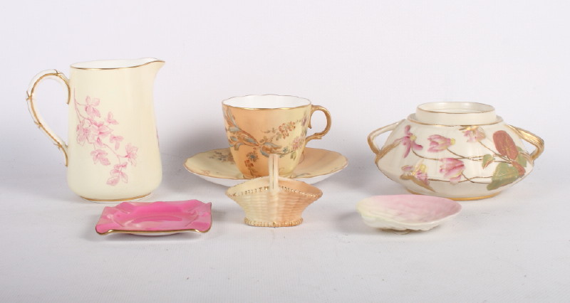 A Royal Worcester blush ivory coffee cup and saucer decorated flowers, a Royal Worcester two-handled