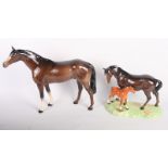 A Beswick model of a mare and foal on shaped base, 7 1/2" high