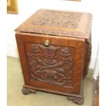 A carved oak coal purdonium of 17th Century design, on scroll supports, 16" wide