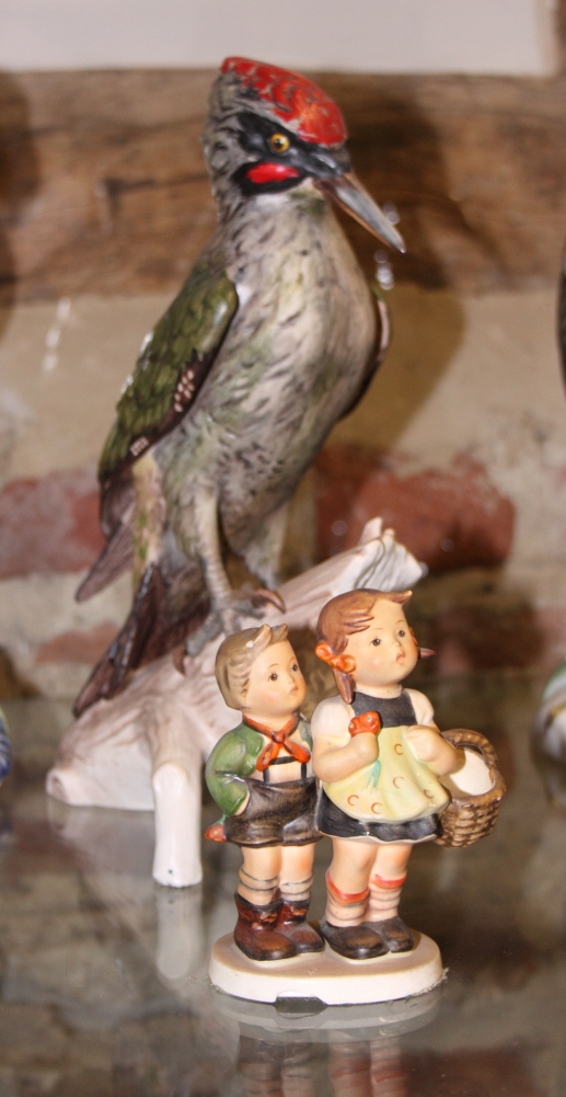 A Goebel ceramic model of a green woodpecker, 11" high, and a Hummel figure of two children