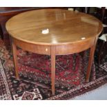 A Georgian mahogany and box line inlaid oval dining table with extra leaf, on square taper supports,