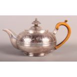 A silver circular teapot with engraved decoration and wooden handle, 17.9oz troy approx