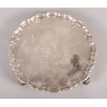 A silver pie crust salver on three scrolled feet, 13.4oz troy approx