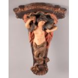 A 19th Century carved and painted wooden bracket formed as a mermaid, 22" high