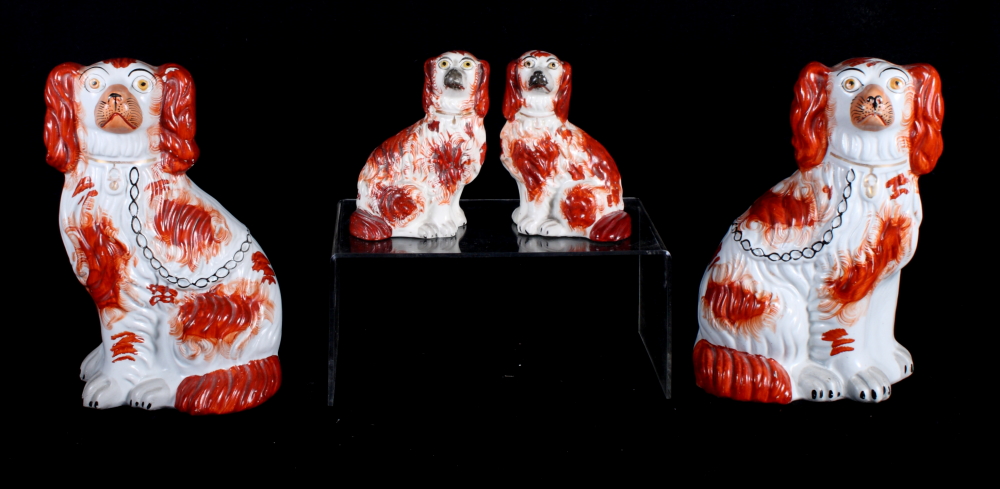 Two pairs of 19th Century Staffordshire seated spaniels with brown sponged decoration