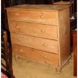 A 19th Century stripped pine chest of four long drawers with turned knobs, 44" wide