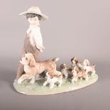 A Lladro china group of a boy with dog and four puppies, in original box