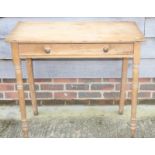 A waxed pine side table, fitted one drawer, on turned supports