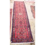 A Hamadan design runner decorated Herati pattern on a red ground, 115" x 30" approx