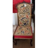 A Victorian rosewood framed prie dieu chair with scroll carved surmount, back and seat upholstered