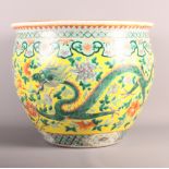 A 19th Century Chinese porcelain fish bowl decorated dragons and flowers on a yellow ground, 14"