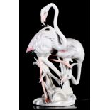 A continental porcelain model of two flamingos and a pair of bisque models of Parula warblers