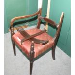 A William IV mahogany carver elbow chair with stuffed over seat, on turned and stretchered