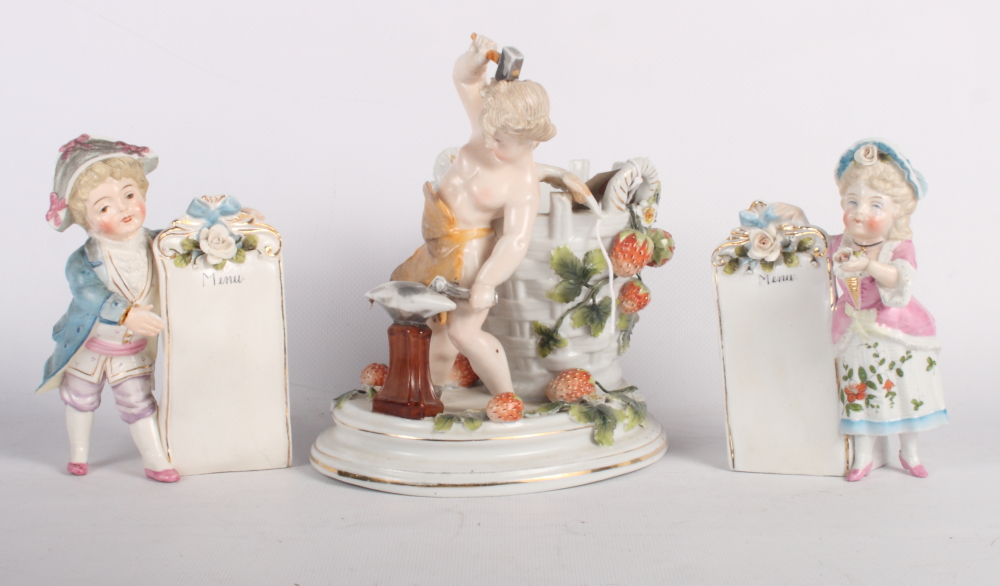 A 19th Century continental porcelain basket decorated cherub blacksmith and a pair of continental