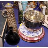 An amethyst glass flask, a German stoneware flagon, a silver plated ice bucket and five decorative