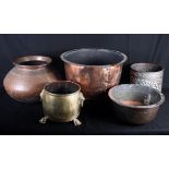 Four copper planters and one brass planter with lion mask handles