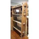 An oak open four-shelf bookcase with fretted sides and through tenon joints