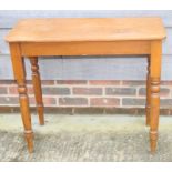 A waxed pine side table, on turned supports, 33" wide