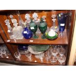 Eight glass decanters, a Bristol blue flagon, two green pressed glass lidded jars, four glass bowls,