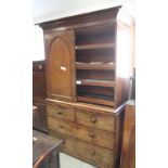 A late 19th Century mahogany linen press, the upper section fitted pull-out trays enclosed Gothic