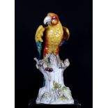 A ceramic model of a parrot on a tree stump, 15" high, and a Portuguese ceramic model of a parrot,